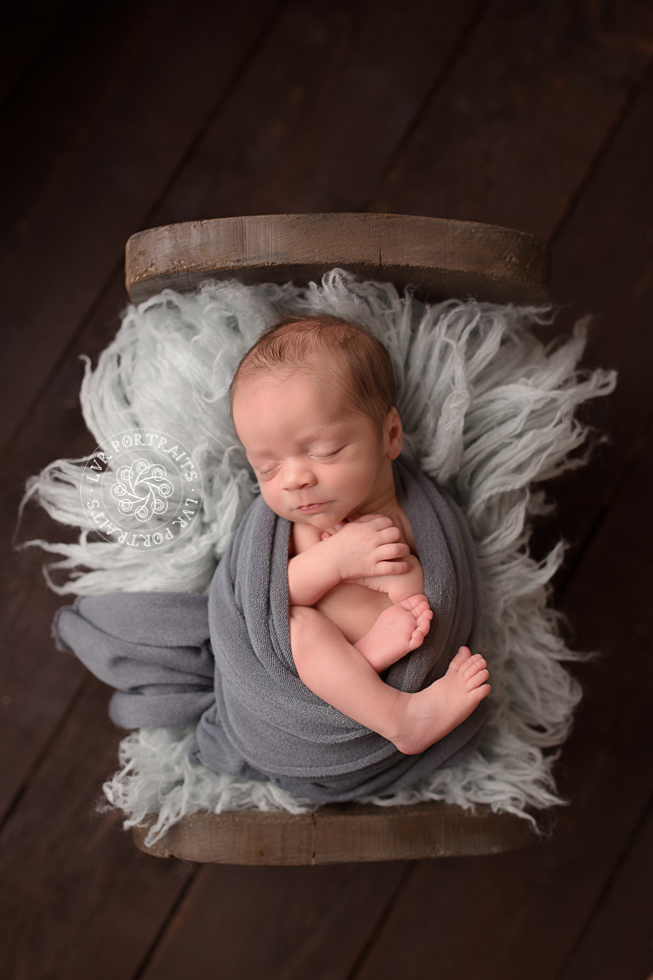 newborn boy in wood bed, wool flokati, newborn photographer,