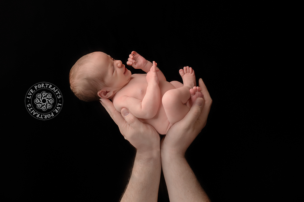 newborn in dad's hands, lancaster newborn photographer