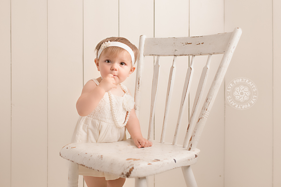One-year cake smash, baby girl on chair
