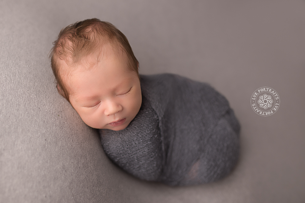 infant photographer, newborn boy, wrapped on beanbag