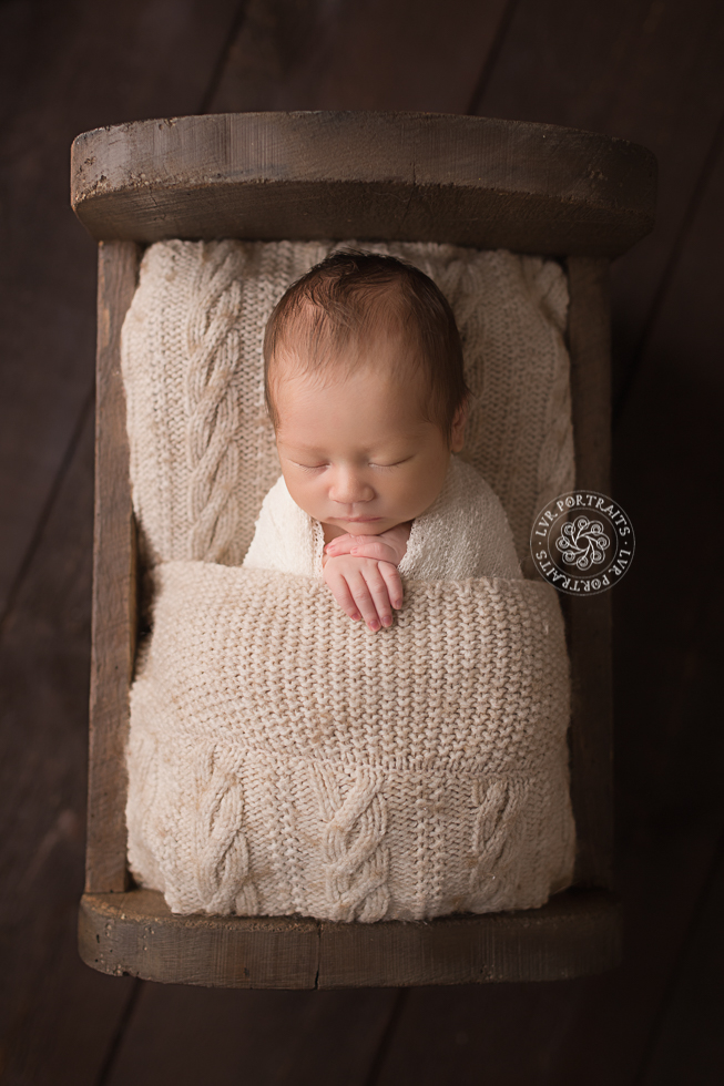 infant photographer, newborn boy, wood bed
