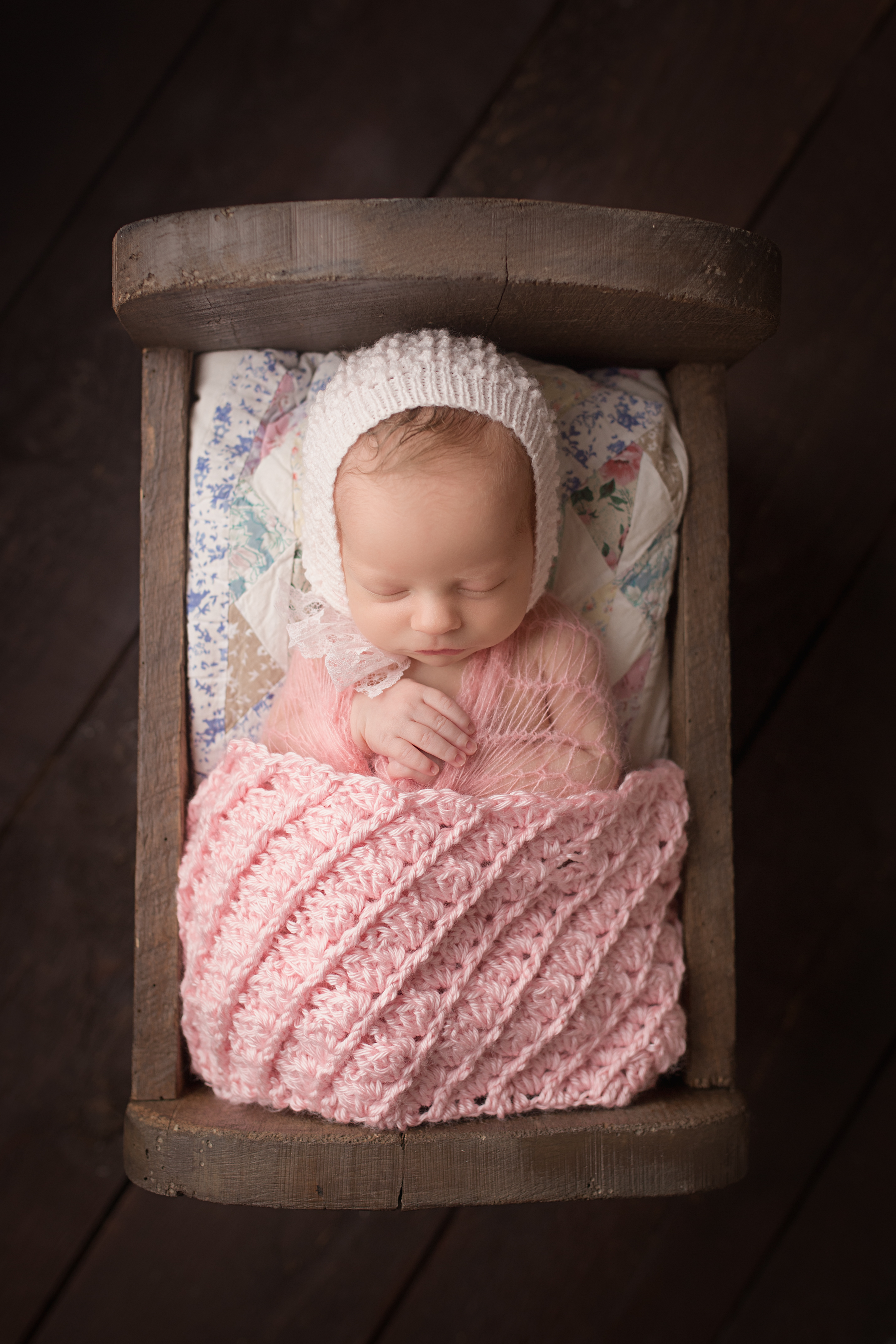 Lancaster-newborn-photography-studio, baby girl in wood bed