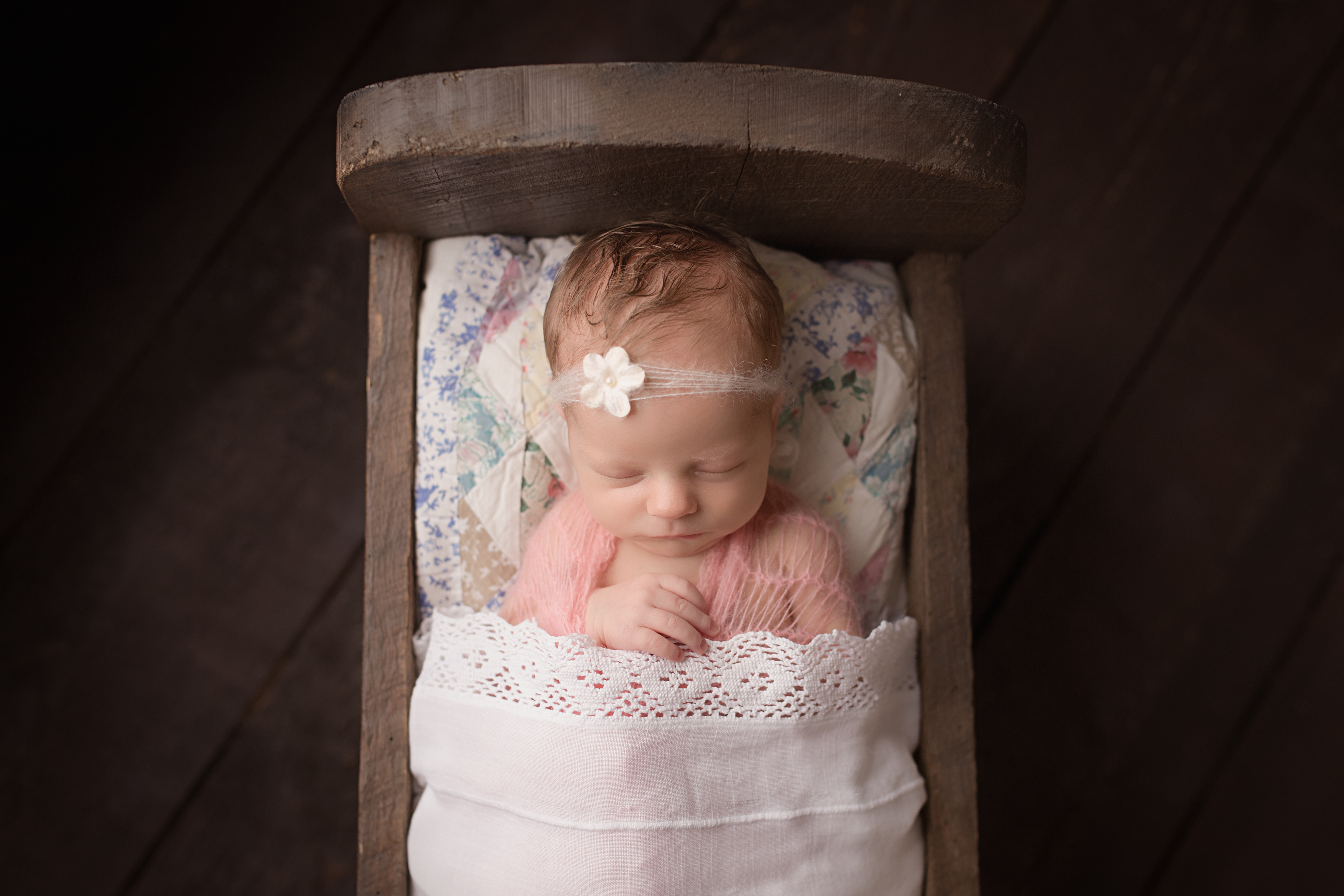 Lancaster-newborn-photography-studio, newborn girl, vintage quilt, wood bed